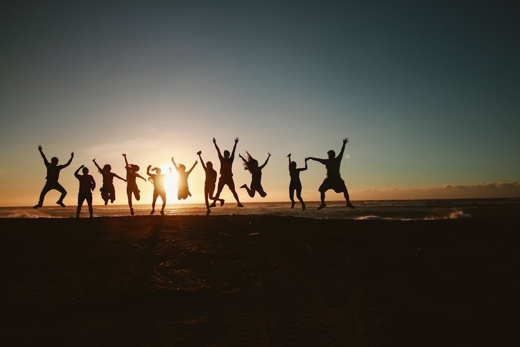 Home Silhouette Photography of Group of People Jumping during Golden Time